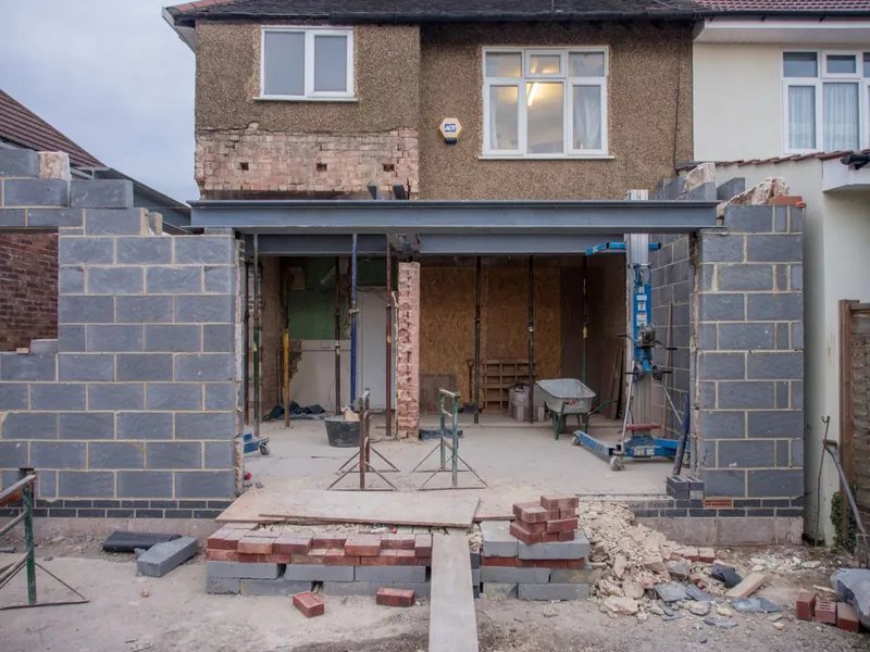 New blockwork walls and steelwork going up during a rebuild on an existing residential footprint