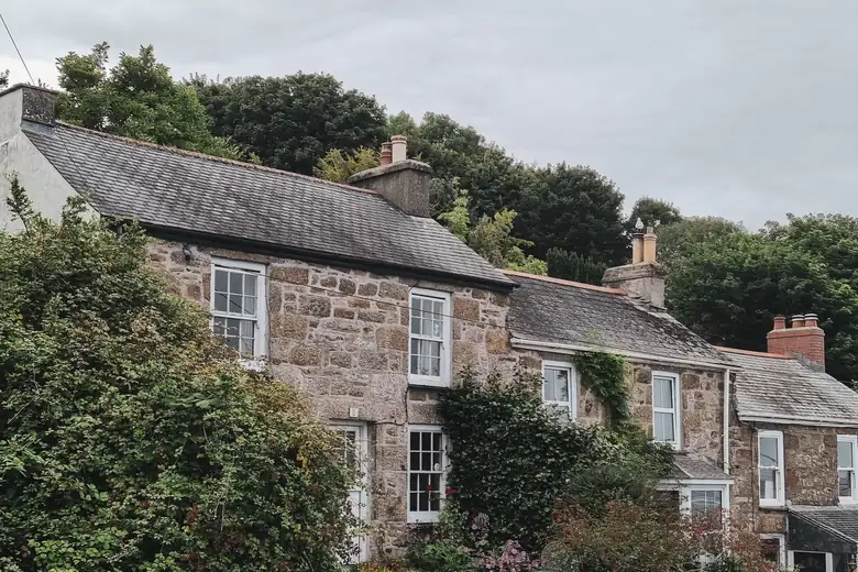 Granite terraced cottages with slate roofs in Newlyn, Cornwall, where garage conversions cost more to match the local stonework