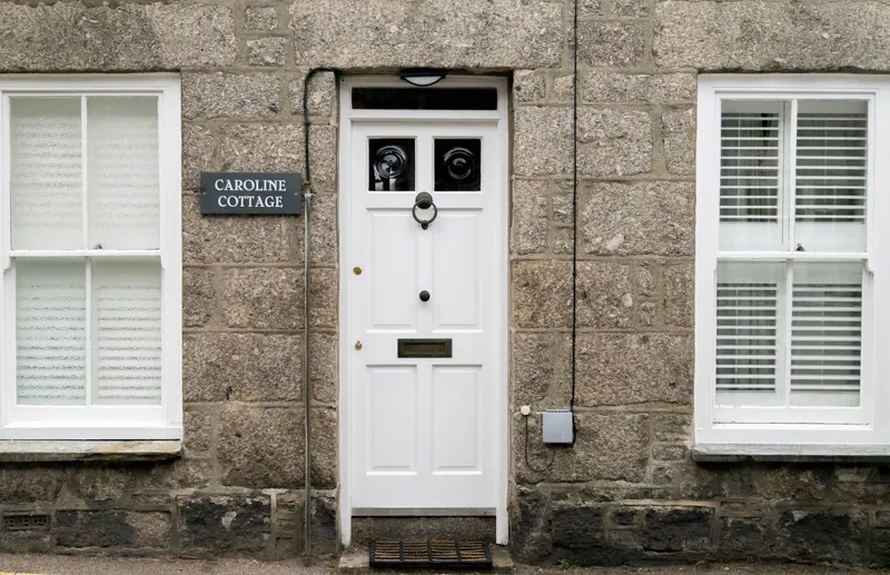 Granite cottage wall in Penzance of the type that forms a shared party wall in Cornwall