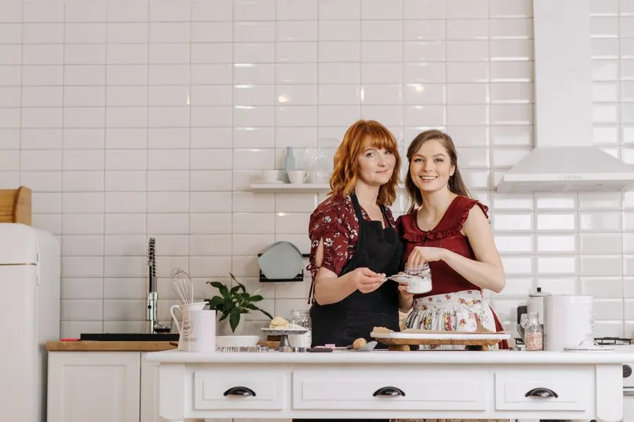 Two generations of a family cooking together, the kind of shared daily life an annexe is built to support