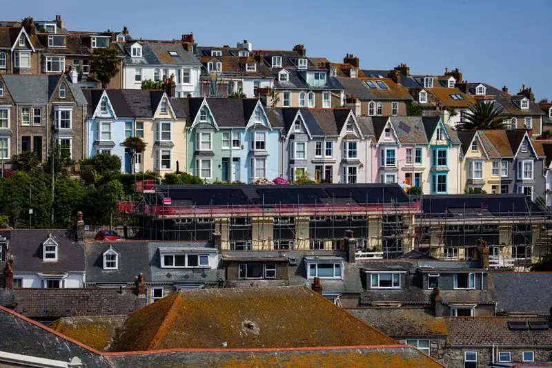 Colourful terraced houses on a Cornish hillside, in a county where second home council tax now runs at double the standard rate