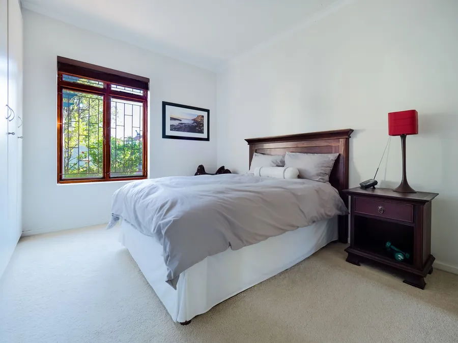 Simply furnished double bedroom of the standard a converted garage or loft needs to reach before it can be let to guests in Cornwall