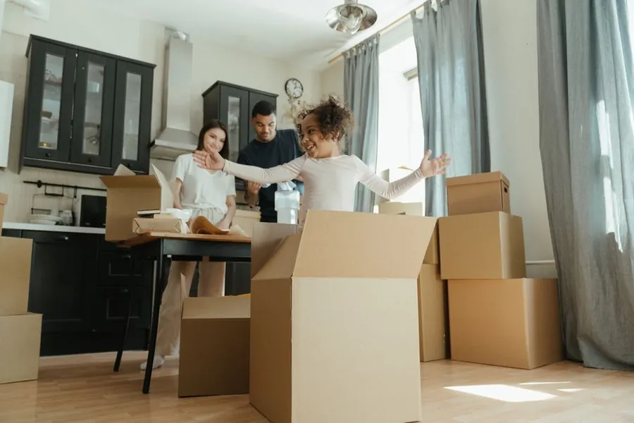 Family unpacking boxes at home, the short decant some households choose for the loudest phase of a conversion