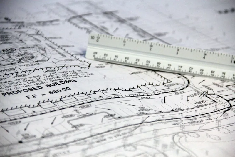 Scale ruler laid over technical building regulations drawings for a loft conversion