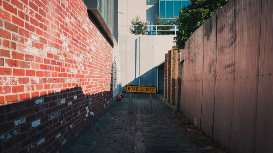 Narrow gap between two adjoining brick properties, the kind of shared boundary the Party Wall Act governs