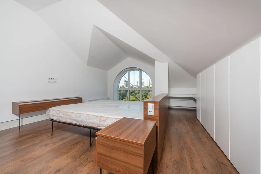 Bedroom under a sloping ceiling created by a rooflight loft conversion