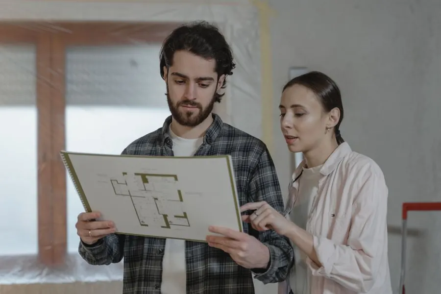 Homeowners going through a floor plan and budget for a loft conversion in Cornwall