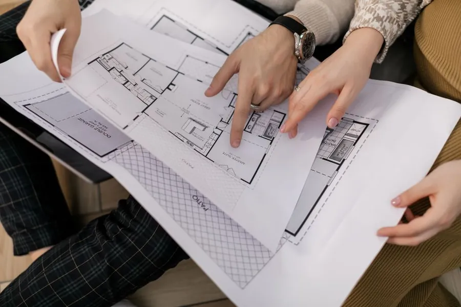 Architectural drawings being reviewed, representing the design and building control fees on a Cornwall loft conversion