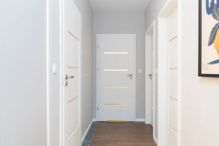 Landing with fire doors in a house, part of the protected escape route required when a Cornish loft conversion creates a third storey