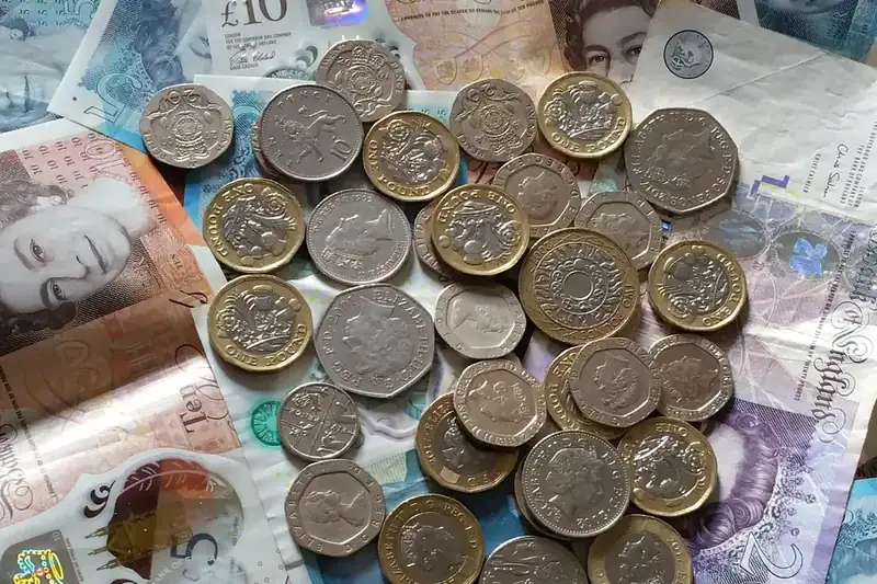British pound coins and notes, illustrating the VAT position on loft and garage conversions in Cornwall