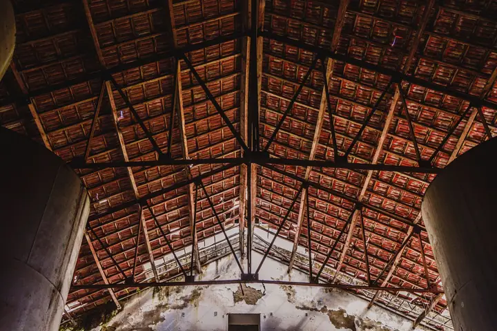 Roof trusses with diagonal web members crossing the roof space, the structure that has to be redesigned before a trussed loft in Cornwall can be converted