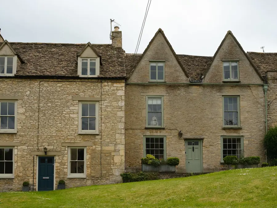 Steeply pitched roofs on stone cottages with gables and small dormers, the kind of roof angle that gives a loft conversion generous headroom