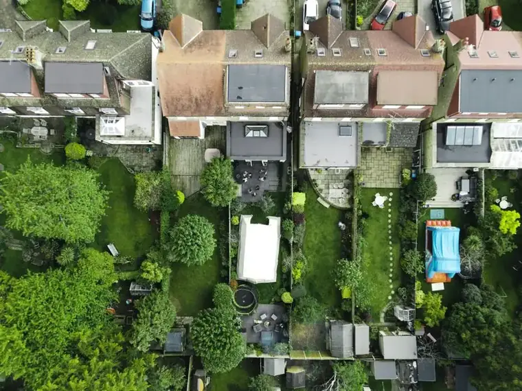 Aerial view of small back gardens behind southern English houses, the limited plot space a Cornish extension has to fit into