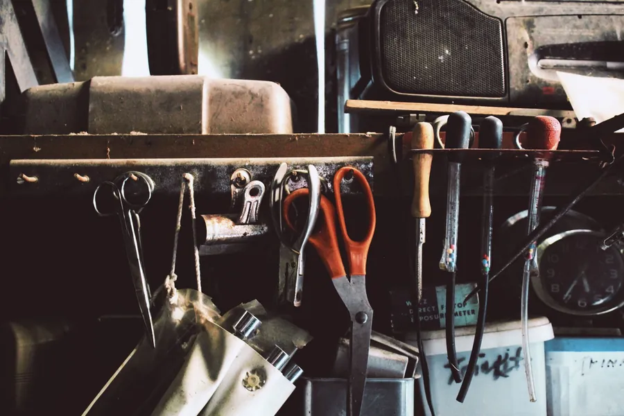 Tools and spares on a garage shelf, the storage a Cornwall garage conversion has to rehouse
