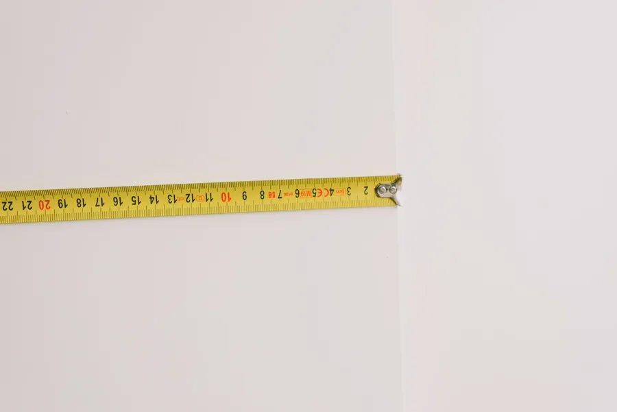 Tape measure stretched across an internal wall, the check that tells you whether a Cornwall garage still fits a car