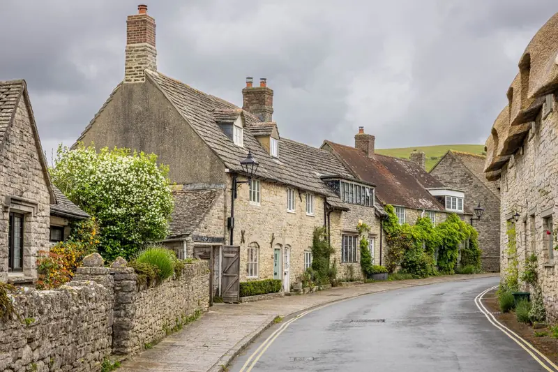 Stone cottages on a narrow village street, the sensitive kind of setting where loft conversion design needs real skill