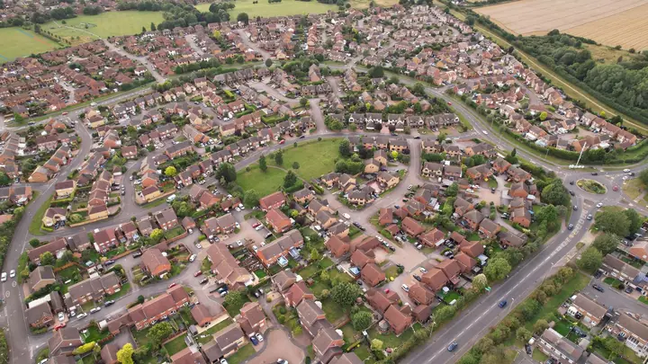 Aerial view of a late twentieth century housing estate of brick houses on cul-de-sacs, the era of Cornish housing built with trussed rafter roofs