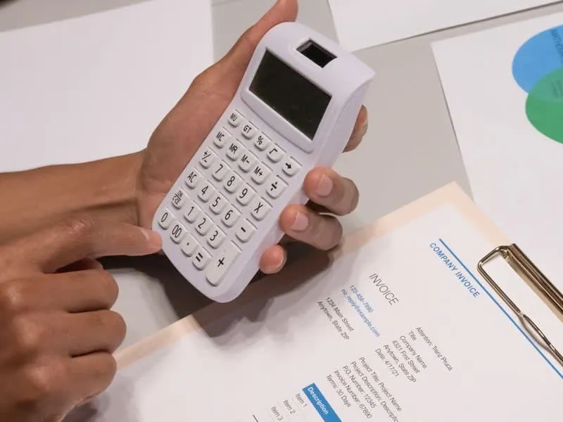 Quote paperwork and a calculator used to check VAT on a conversion project