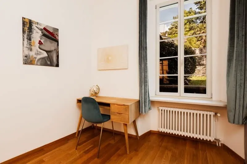 Warm, dry converted garage in use as a home office with a radiator under the window