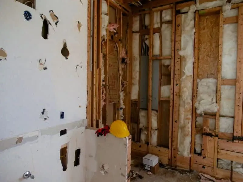 Stud wall and insulation being installed during a garage conversion to meet building regulations