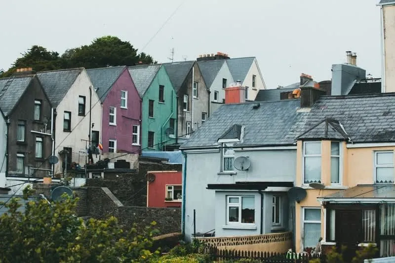 Terraced houses with slate roofs on a Cornish street where party wall notices apply to loft conversions