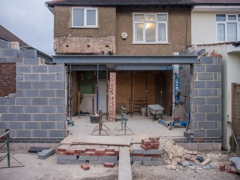 Scaffolding up against a house during conversion work, part of sequencing two projects