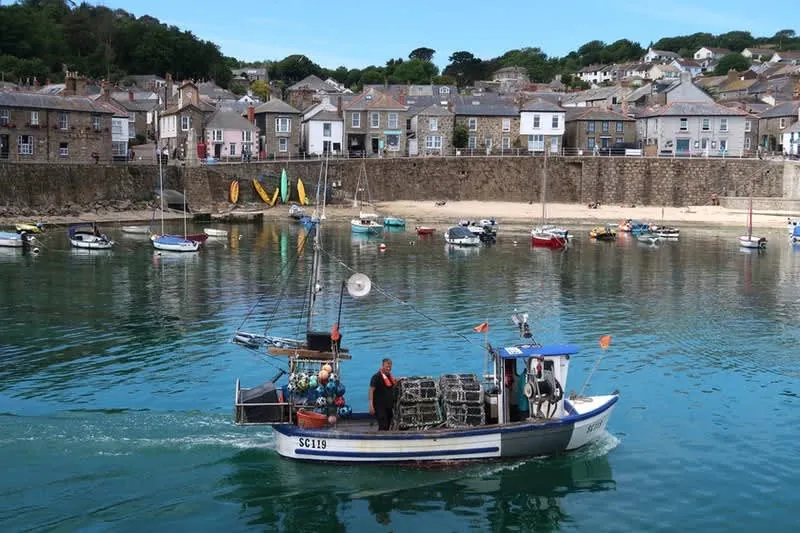 Cornish harbour village with houses packed above the quay, where off-street parking is scarce and valuable