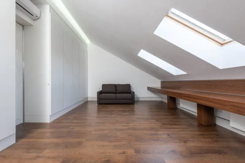 Timber roof trusses inside a bungalow loft before conversion work in Cornwall