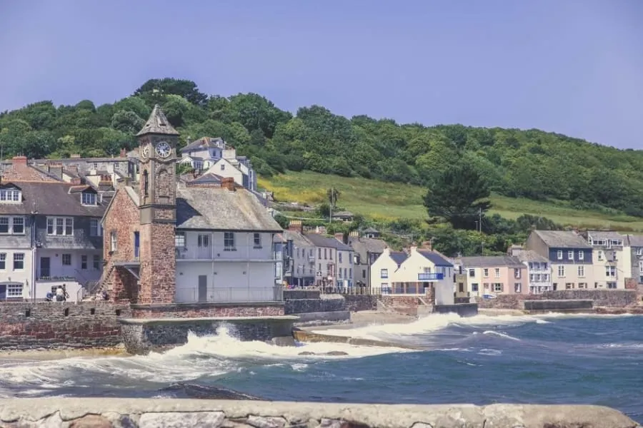 Cornish coastal village of slate-roofed cottages packed tightly along the shoreline