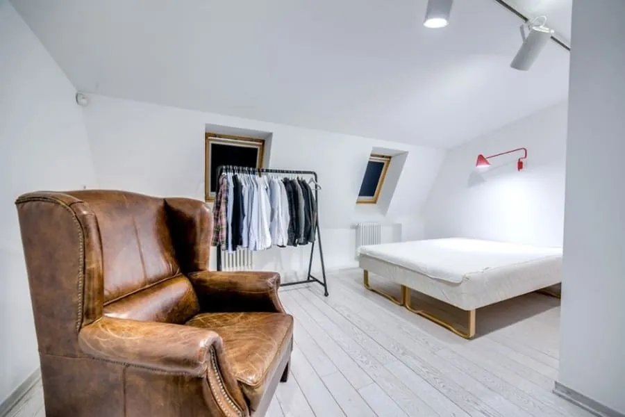 Loft conversion bedroom in Cornwall with an armchair beneath a rooflight