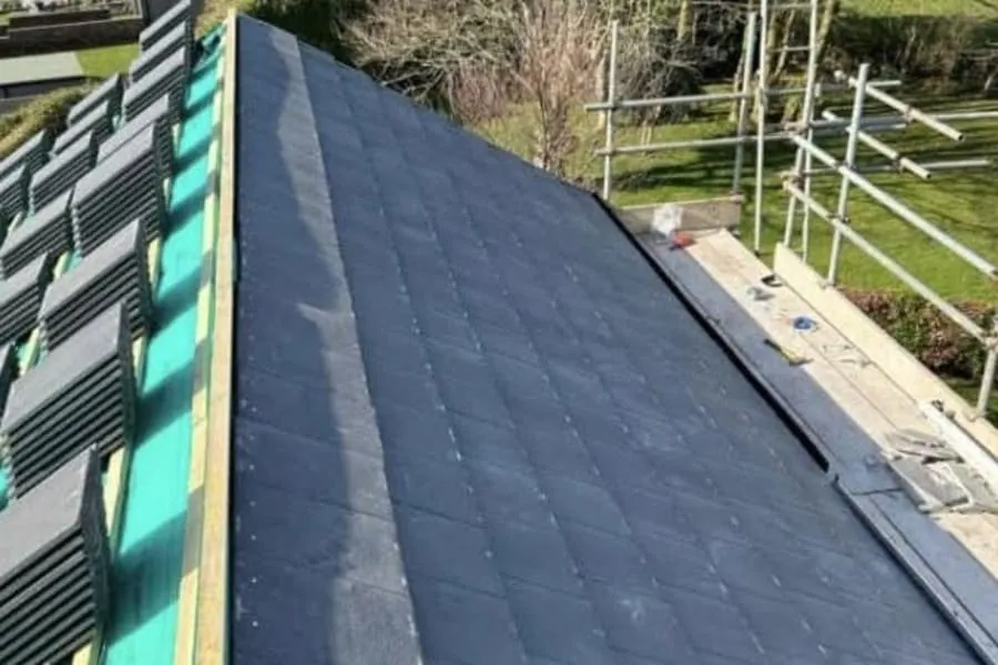 Roof stripped back to the rafters with breather membrane and battens going on during a loft conversion in Cornwall